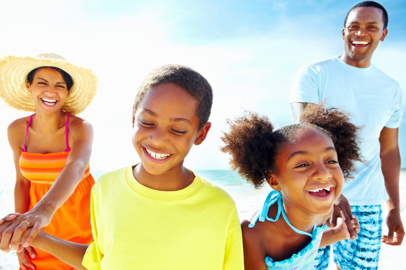 African-American family enjoying beach vacation