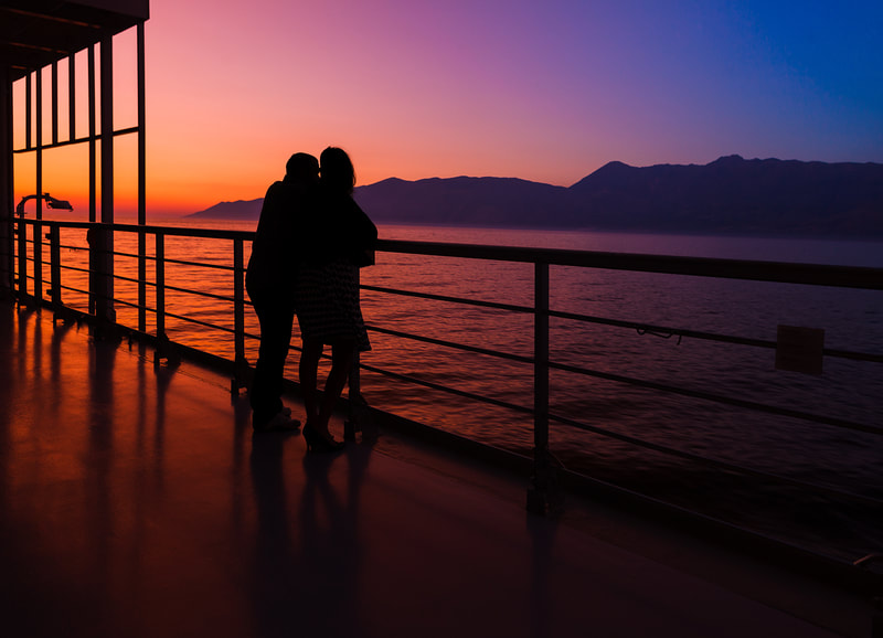 couple on cruise deck at sunset